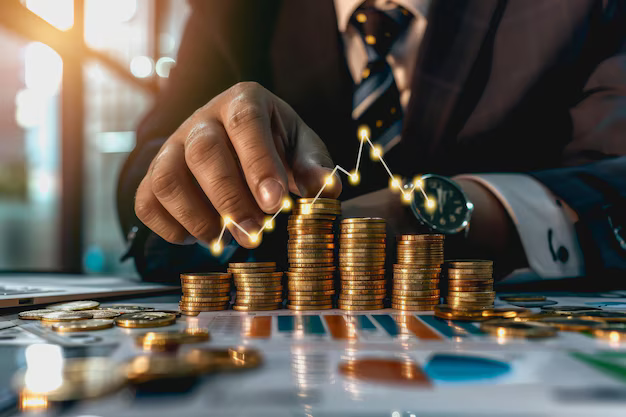 Businessman stacking glowing coins for financial growth